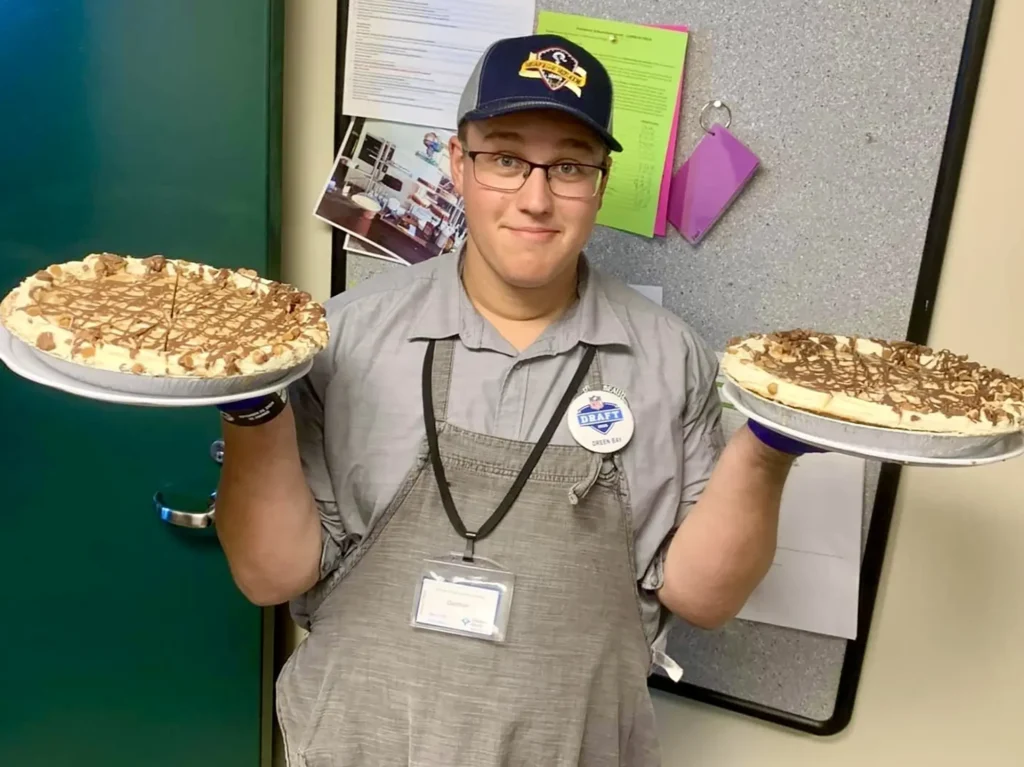 Man holding pies made for an Our Lady of Good Success Academy fundraiser